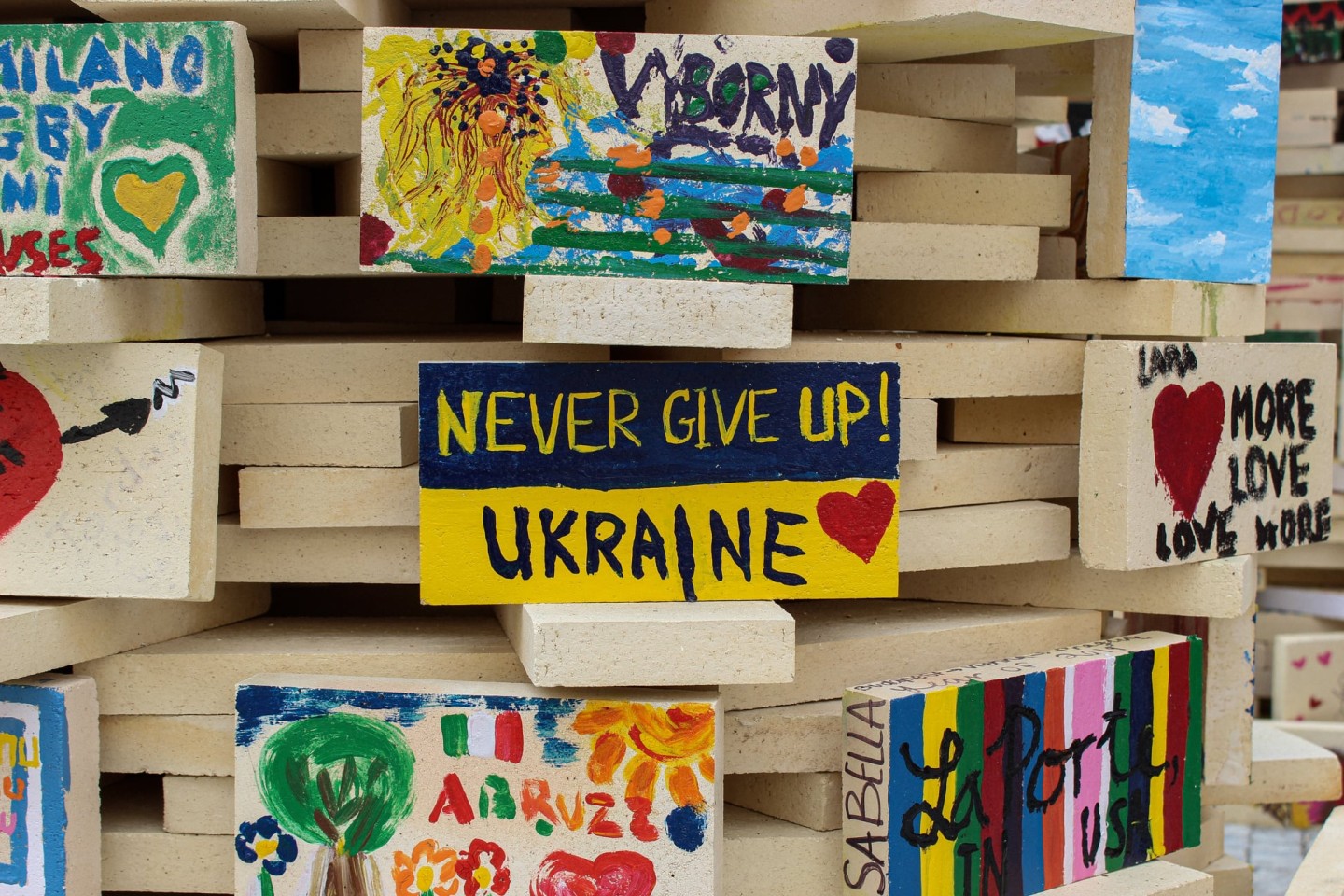 building block, painted with colourful messages in support of Ukraine, such as 